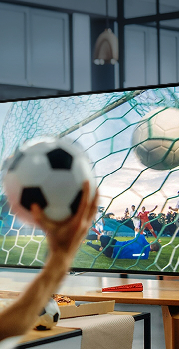 An image of several people holding a soccer ball and watching a soccer match.