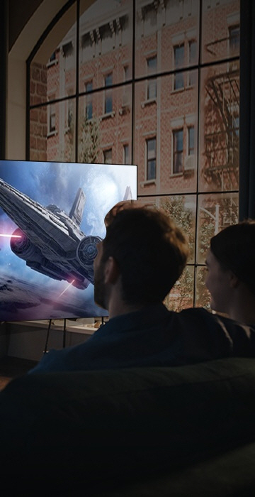 An image of a man and a woman watching a sci-fi movie.